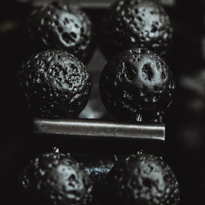 Positive Empathetic's Matte Black Beaded Watch, 38mm lava rock bracelet — full watch on a flat surface