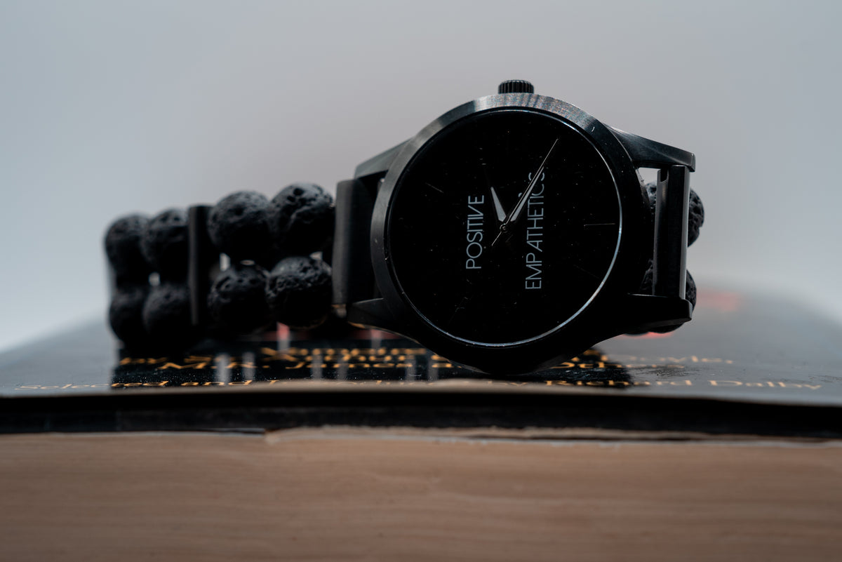 Positive Empathetic's Matte Black Beaded Watch, 38mm lava rock bracelet — dial and bracelet detail